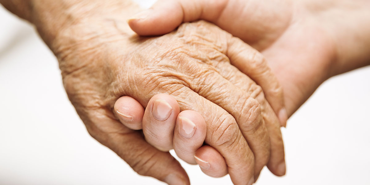 Hand of an elderly being held